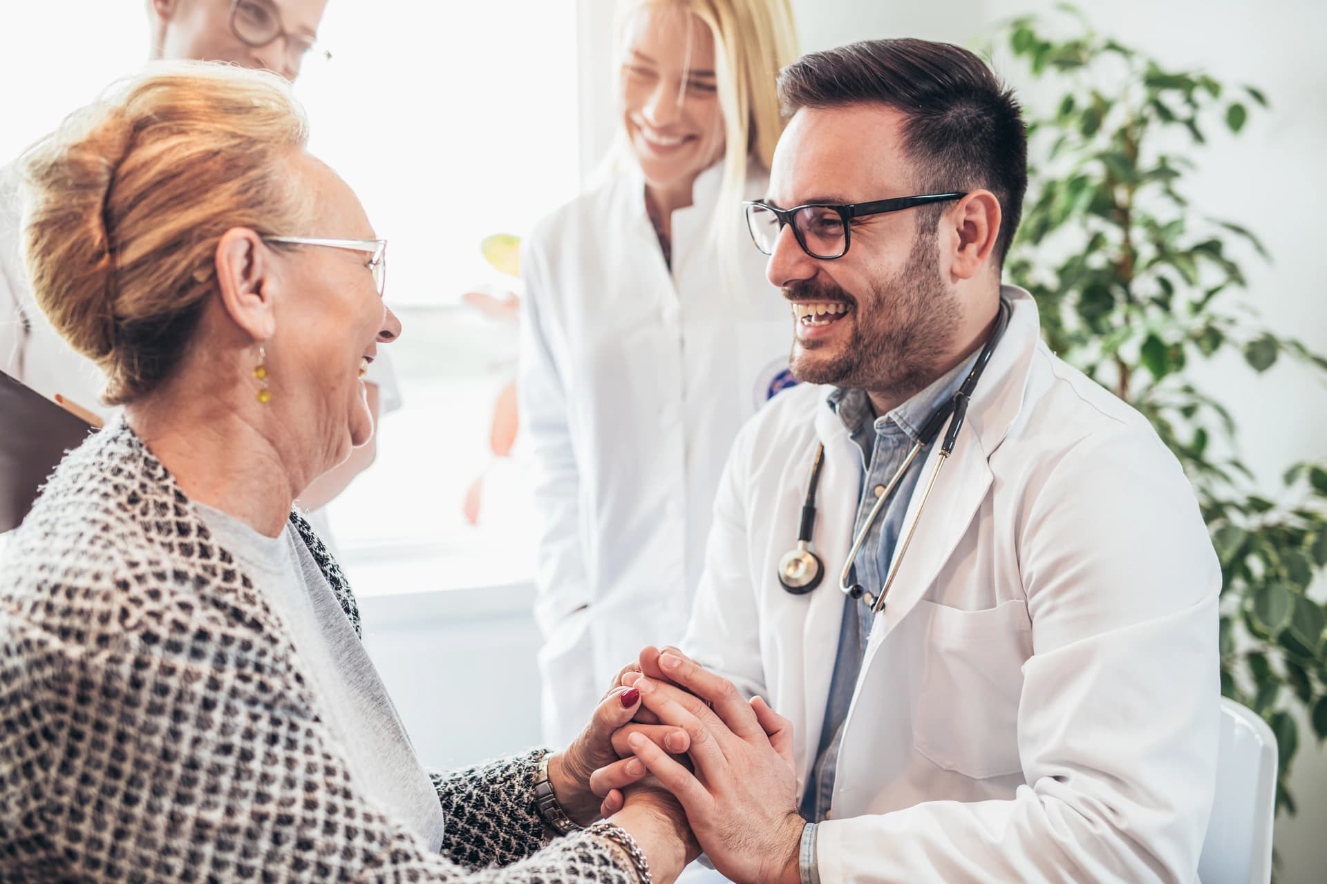 Group of doctors during a home visit with senior people